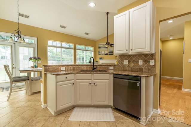 5656 Cambridge Bay Dr, Charlotte, NC 28269 - kitchen featuring stainless steel dishwasher, a sink, a peninsula, lofted ceiling, and backsplash