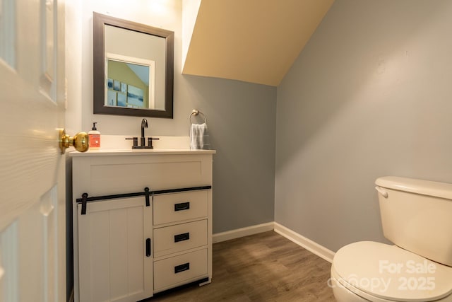 5656 Cambridge Bay Dr, Charlotte, NC 28269 - half bathroom featuring wood finished floors, toilet, vanity, and baseboards
