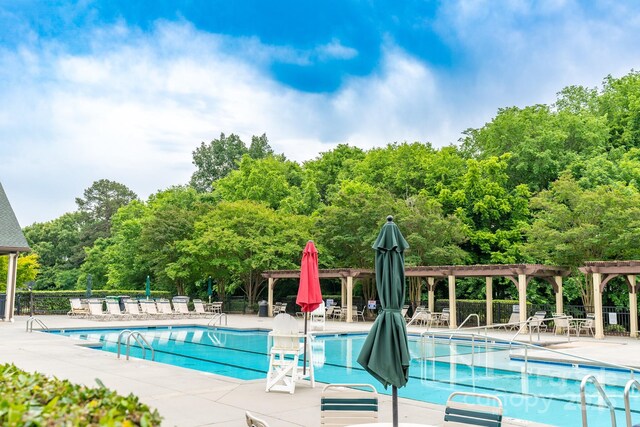 5656 Cambridge Bay Dr, Charlotte, NC 28269 - community pool with a pergola, fence, and a patio area
