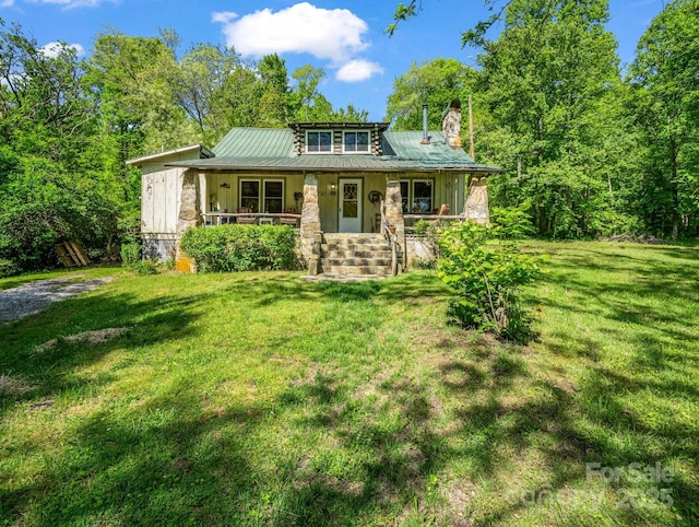 51 Moffitt Rd, Horse Shoe, NC 28742 - view of front of house with covered porch, a front lawn, a chimney, and metal roof