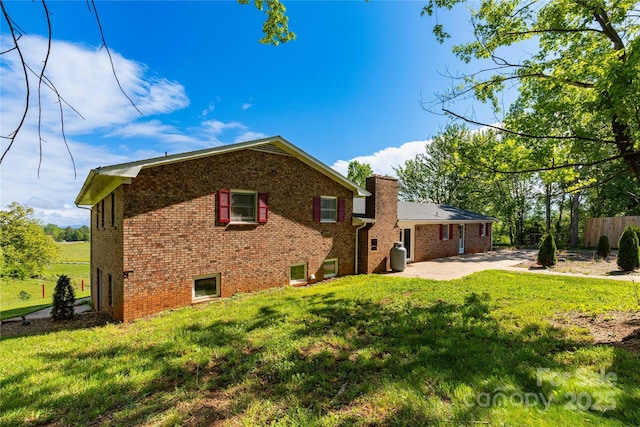 67 Old Turkey Creek Rd, Leicester, NC 28748 - rear view of house with brick siding, a patio, and a chimney