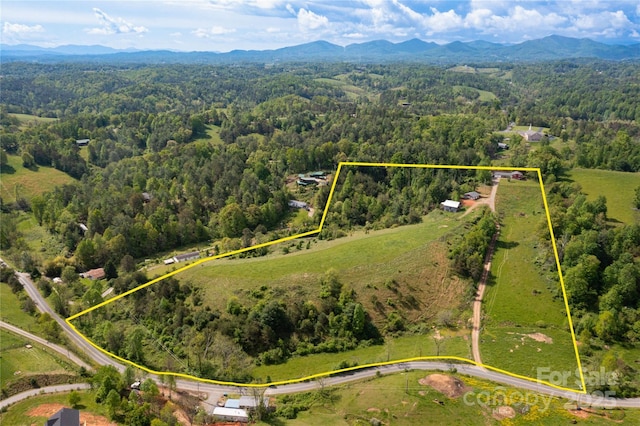 67 Old Turkey Creek Rd, Leicester, NC 28748 - aerial view of property's location with a heavily wooded area, property parcel outlined, and a mountainous background