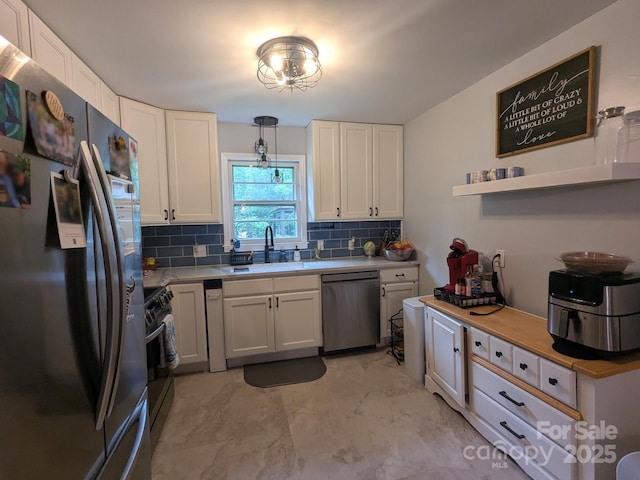 3116 Pilgrim Rd, Chester, SC 29706 - kitchen with stainless steel appliances, a sink, tasteful backsplash, light countertops, and white cabinets