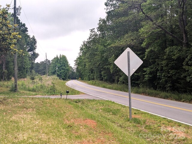 3116 Pilgrim Rd, Chester, SC 29706 - view of asphalt road with traffic signs and a view of trees