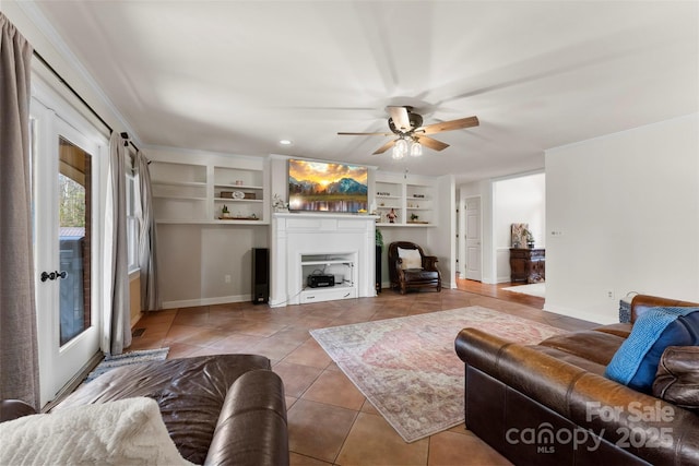 148 Fairway Dr, Forest City, NC 28043 - living area with light tile patterned flooring, a ceiling fan, a fireplace, and built in shelves