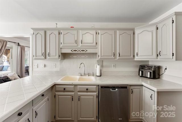 148 Fairway Dr, Forest City, NC 28043 - kitchen featuring stainless steel dishwasher, a sink, tile counters, and tasteful backsplash