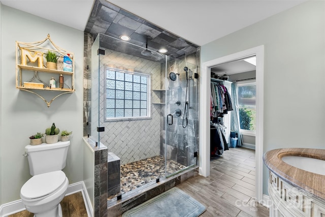 148 Fairway Dr, Forest City, NC 28043 - bathroom featuring healthy amount of natural light, a stall shower, wood finished floors, and toilet