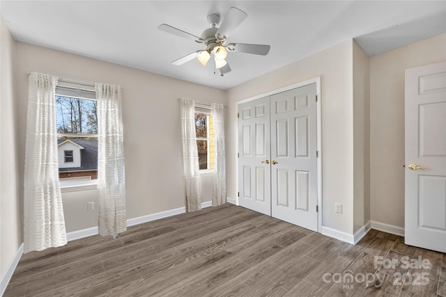 148 Fairway Dr, Forest City, NC 28043 - unfurnished bedroom with a closet, wood finished floors, baseboards, and a ceiling fan