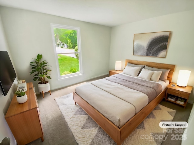 carpeted bedroom featuring baseboards