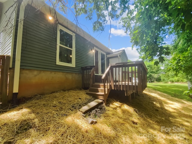 view of property exterior with a deck