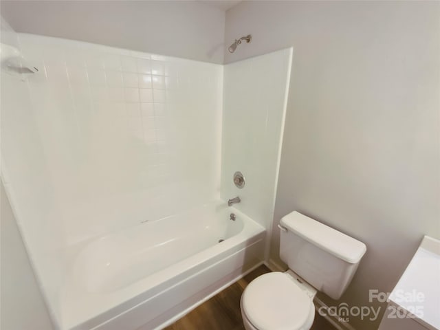 full bathroom with toilet, shower / tub combination, and wood finished floors