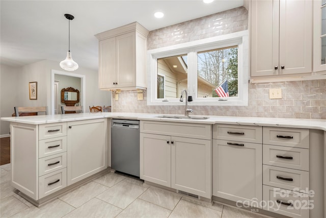 64 Timberidge Dr, Lake Wylie, SC 29710 - kitchen with dishwasher, a sink, a peninsula, decorative backsplash, and light stone countertops