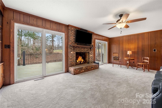 64 Timberidge Dr, Lake Wylie, SC 29710 - unfurnished living room featuring carpet, wooden walls, ceiling fan, and a brick fireplace