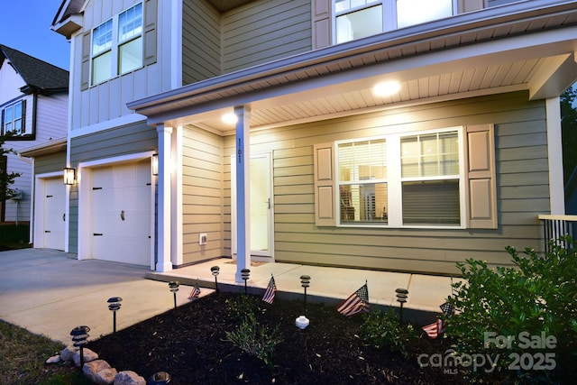 161 Old Harbor Dr, Mount Gilead, NC 27306 - view of property exterior with an attached garage, concrete driveway, and board and batten siding