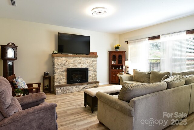 161 Old Harbor Dr, Mount Gilead, NC 27306 - living room with light wood-style floors and a stone fireplace