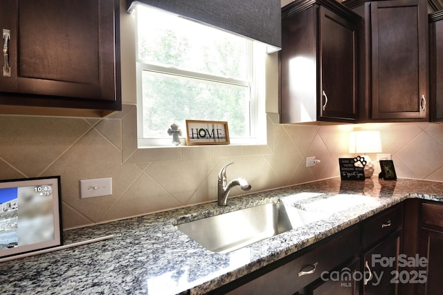 161 Old Harbor Dr, Mount Gilead, NC 27306 - kitchen featuring dark brown cabinetry, tasteful backsplash, and dark stone countertops