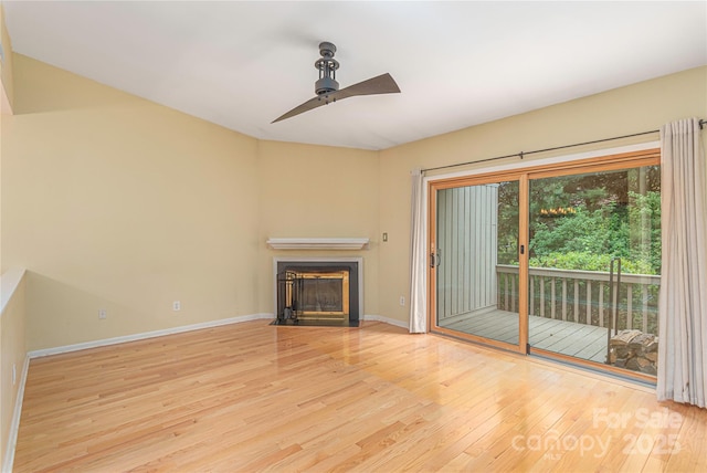 111 Clubwood Ct, Asheville, NC 28803 - unfurnished living room with ceiling fan, wood finished floors, a fireplace with flush hearth, and baseboards