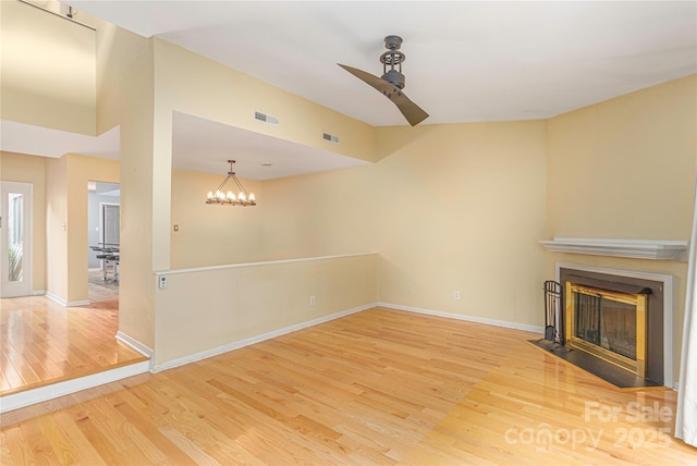 111 Clubwood Ct, Asheville, NC 28803 - unfurnished living room featuring wood finished floors, a ceiling fan, a fireplace with flush hearth, and baseboards