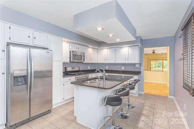 111 Clubwood Ct, Asheville, NC 28803 - kitchen with stainless steel appliances, a sink, light tile patterned floors, decorative backsplash, and recessed lighting