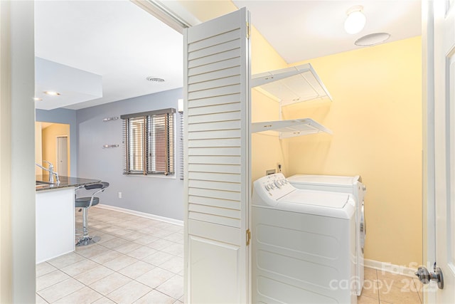 111 Clubwood Ct, Asheville, NC 28803 - washroom featuring washing machine and dryer, light tile patterned flooring, and baseboards