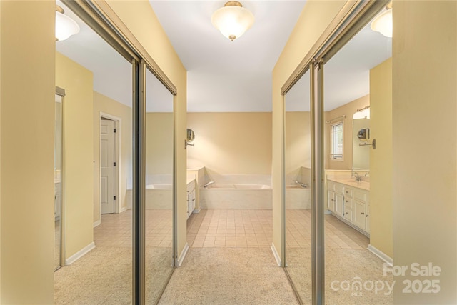 111 Clubwood Ct, Asheville, NC 28803 - hallway featuring light colored carpet, light tile patterned floors, and a sink