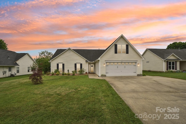 traditional home featuring concrete driveway, a front yard, and a garage