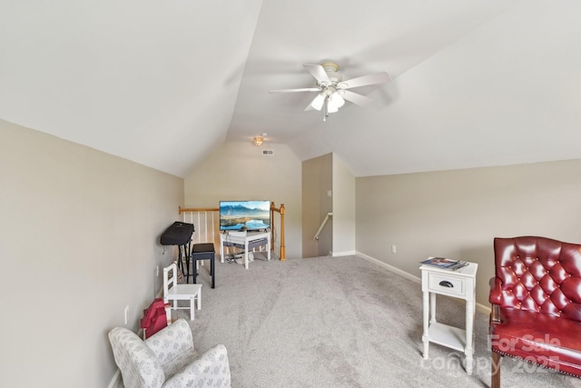 sitting room with vaulted ceiling, a ceiling fan, carpet flooring, an upstairs landing, and baseboards