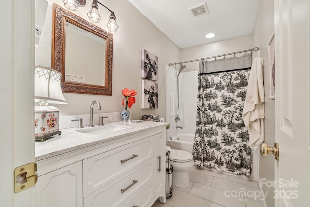 bathroom featuring vanity, tile patterned flooring, toilet, and shower / bath combination with curtain