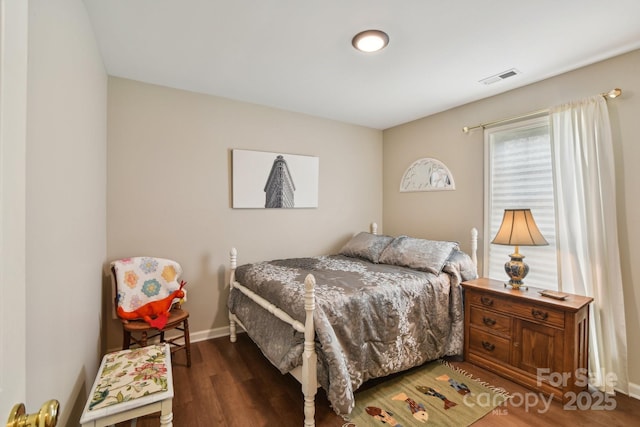bedroom featuring wood finished floors and baseboards