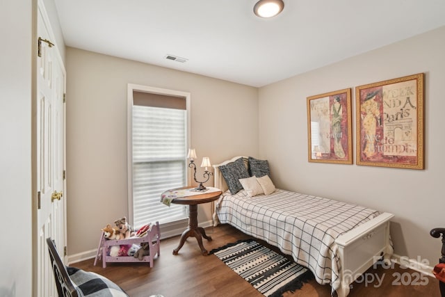 bedroom featuring baseboards and wood finished floors