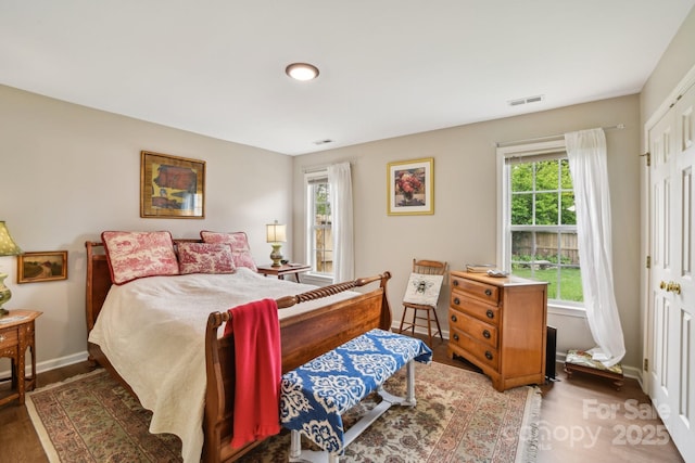 bedroom with baseboards and wood finished floors