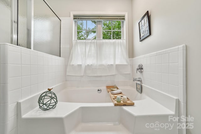 full bathroom with a bath