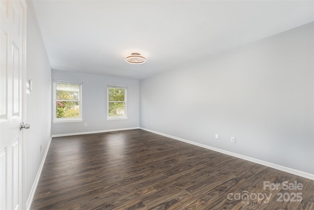 2112 Flint Glenn Ln, Charlotte, NC 28262 - spare room with baseboards and dark wood-type flooring