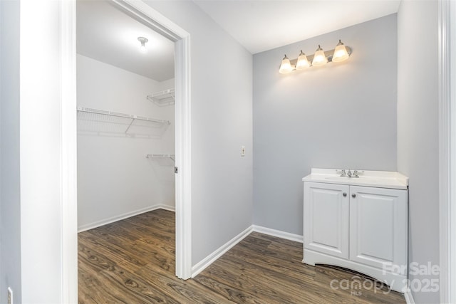 2112 Flint Glenn Ln, Charlotte, NC 28262 - bathroom with wood finished floors, baseboards, a walk in closet, and vanity