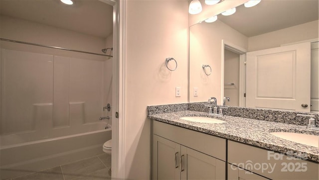 bathroom featuring double vanity, toilet,  shower combination, and tile patterned floors