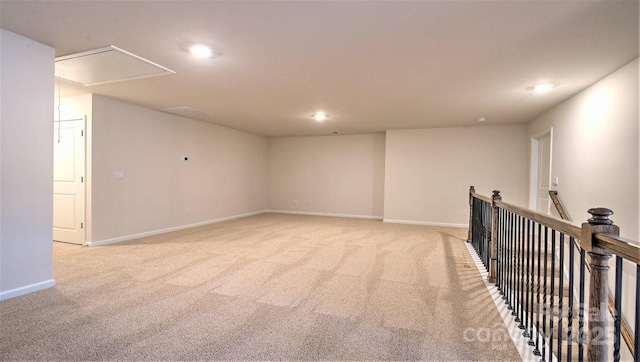 spare room with attic access, light carpet, recessed lighting, and baseboards