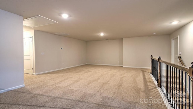 unfurnished room with attic access, light carpet, recessed lighting, and baseboards