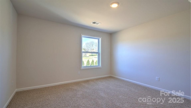 spare room with carpet and baseboards