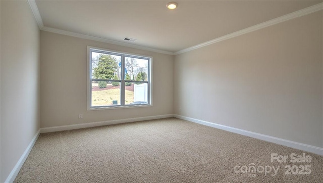 carpeted spare room featuring ornamental molding and baseboards