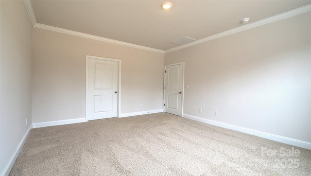 spare room with carpet flooring, ornamental molding, and baseboards