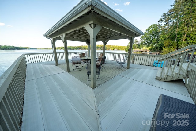 24264 Strand Dr, Albemarle, NC 28001 - wooden deck with a water view and outdoor dining area
