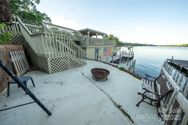 24264 Strand Dr, Albemarle, NC 28001 - view of patio / terrace featuring stairway, a fire pit, a water view, and a boat dock