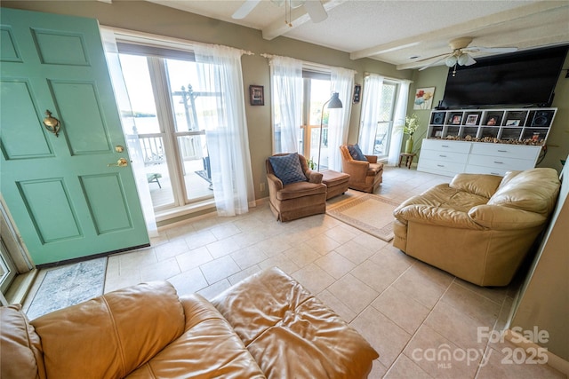 24264 Strand Dr, Albemarle, NC 28001 - living room with a ceiling fan, light tile patterned floors, beam ceiling, and a textured ceiling