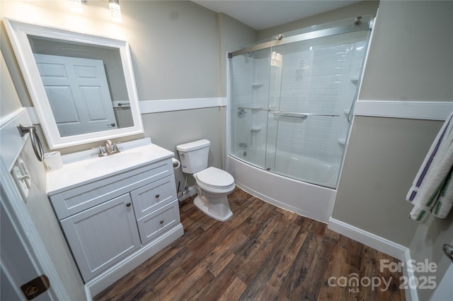 24264 Strand Dr, Albemarle, NC 28001 - bathroom with toilet, wood finished floors, vanity, and enclosed tub / shower combo