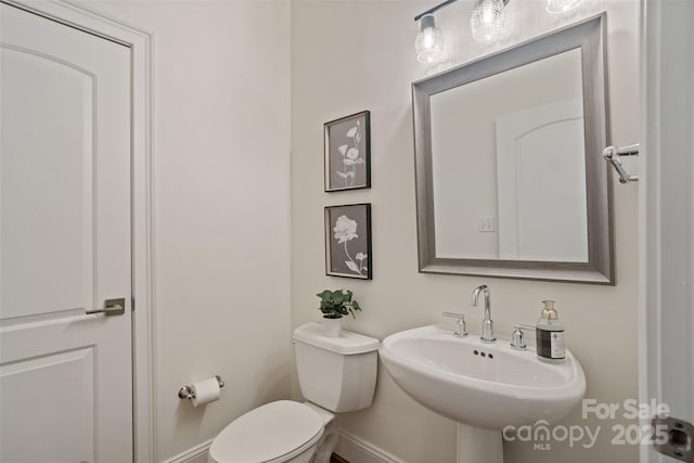 400 N Church St Unit 226, Charlotte, NC 28202 - bathroom with toilet, a sink, and baseboards