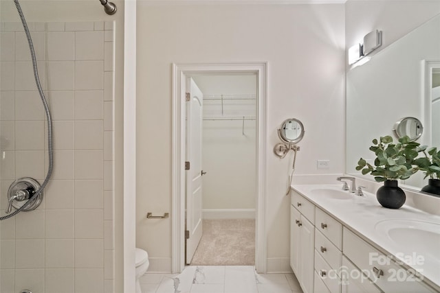 400 N Church St Unit 226, Charlotte, NC 28202 - full bathroom with double vanity, a spacious closet, a shower, toilet, and baseboards