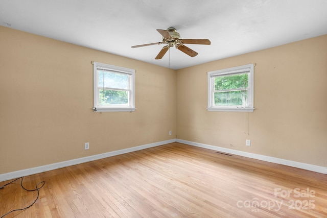 1753 28th St NE, Hickory, NC 28601 - unfurnished room featuring plenty of natural light, wood finished floors, baseboards, and a ceiling fan