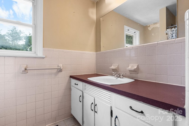 1753 28th St NE, Hickory, NC 28601 - full bath featuring tile walls, vanity, tile patterned flooring, a wainscoted wall, and curtained shower