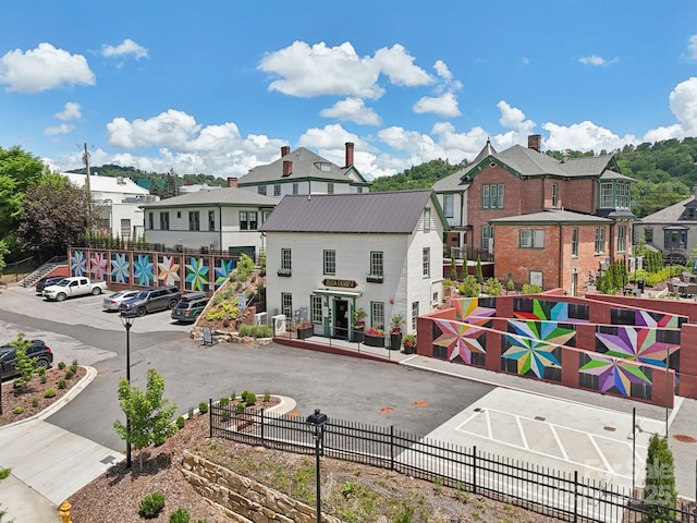 view of building exterior with a residential view and fence