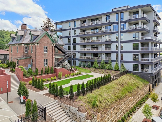 view of apartment building / complex with fence